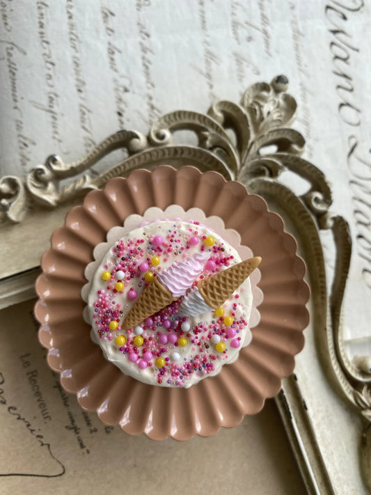 Decorative brooch with ice cream cone design on a vintage background